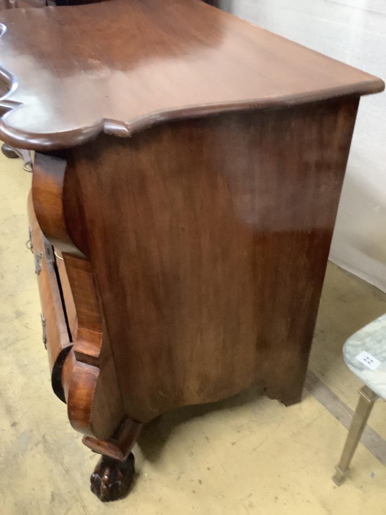 A 19th century and later Dutch mahogany bombe chest of three long drawers, raised on claw and ball feet